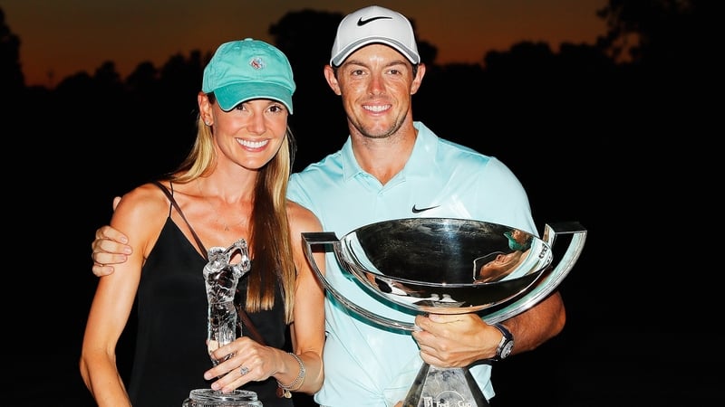 Rory McIlroy poses alongside his fiancé Erica Stoll and the FedExCup and TOUR Championship trophies after his victory