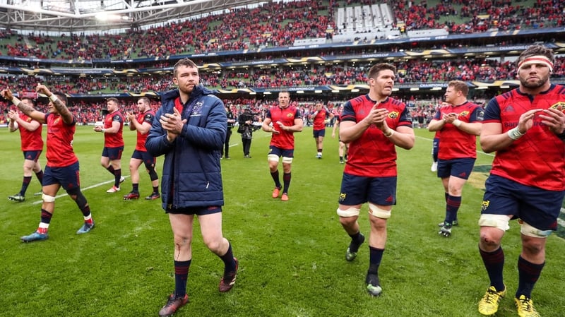 Munster players salute the fans