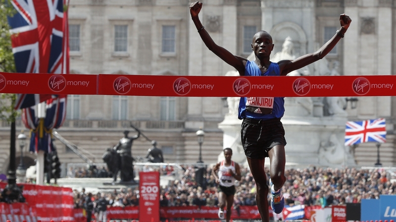 Daniel Wanjiru crosses the line ahead of Bekele