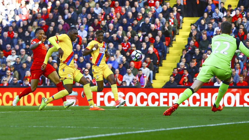Christian Benteke scores the first of his two goals at Anfield