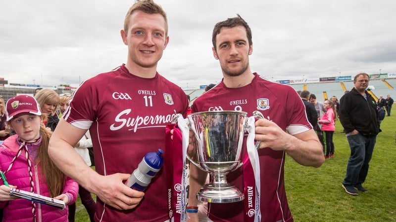Joe Canning (L) and Galway captain David Burke celebrate with the league trophy in Limerick