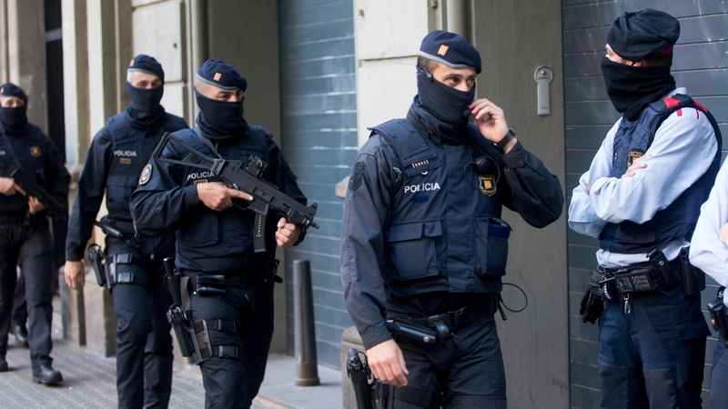 Catalonian regional police take part in a raid in a residential building