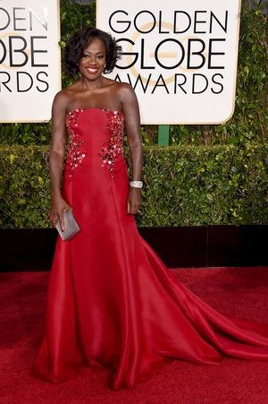 Red suits her so well. Viola had beautiful curls while wearing a Donna Karan Atelier gown at the 2015 Golden Globes, nominated for her role in the TV series 'How to Get Away with Murder'.
