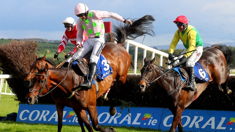 Sizing John (r) jumps the last behind Djakadam in the 2017 Punchestown Gold Cup