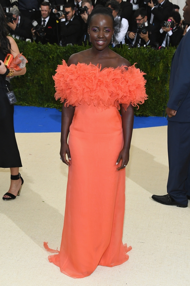 Radiant, Lupita Nyong'o wore a feathers Prada gown.