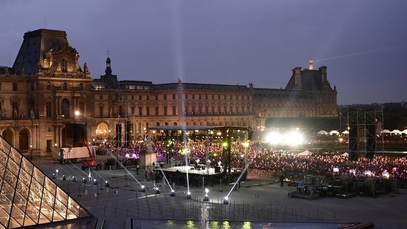 Supporters of Emmanuel Macron celebrate in front of the Louvre Museum in Paris
