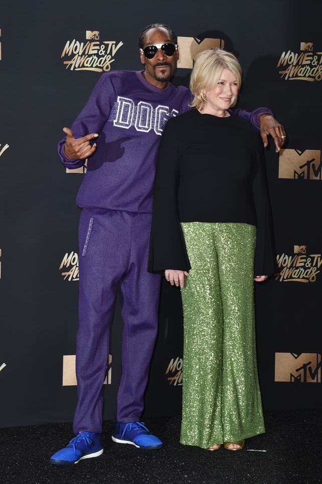 BFFS Snoop Dogg and Martha Stewart pose on the red carpet. Snoop went for a casual purple tracksuit while Martha looked snazzy in green sequins.