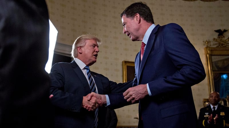 Donald Trump shakes hands with James Comey at the White House earlier this year