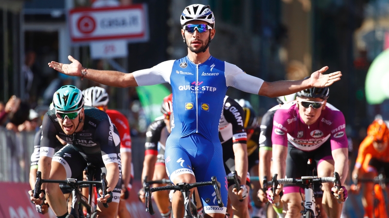 Fernando Gaviria crosses the line ahead of Sam Bennett (left)