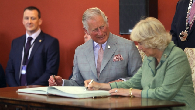 The Prince of Wales and the Duchess of Cornwall sign the visitors book in Kilkenny Castle