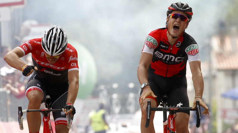 Swiss BMC rider Silvan Dillier (R) celebrates as he crosses the finish line ahead Belgian rival Jasper Stuyven