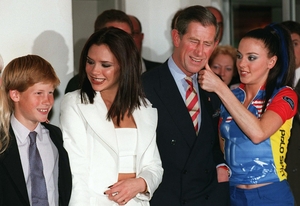 Prince Harry poses with Victoria Beckham as Sporty Spice aka Mel C wipes lipstick from Prince Charles' cheek (!) before The Spice Girls performed in Johannesburg in 1997.