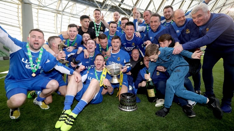 Sheriff players and coaches celebrate with the FAI Junior Cup
