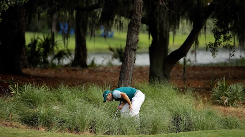 Garcia hunts for his ball on the second at TPC Sawgrass