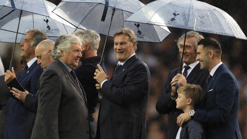 Joe Kinnear is welcomed on to the White Hart Lane ptich by Robbie Keane