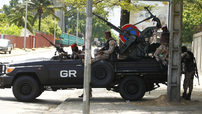 Rebel soldiers take up position along a street near the entrance of Ivory Coast's army headquarters in Abidjan