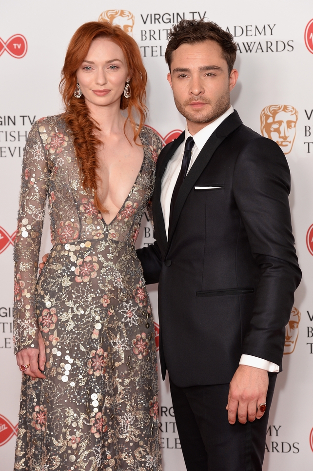 Poldark's Eleanor Tomlinson wore a sheer floral dress with plunging neckline. Here she poses next to Gossip Girl star Ed Westwick who opted for a classic black suit and tie.