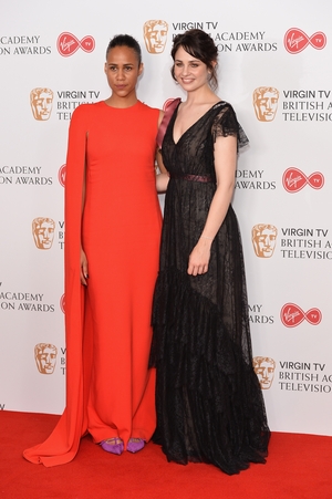 Actress Zawe Ashton (L) wore a Stella McCartney dress and Loboutin shoes while and Tuppence Middleton (R) wore an Erdem London dress and Jimmy Choo shoes.