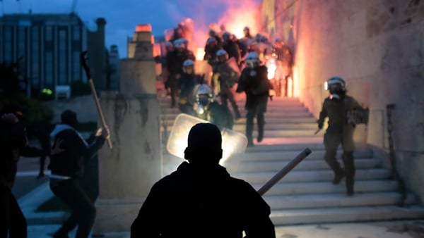 Police clash with protesters in front of the Greek Parliament building
