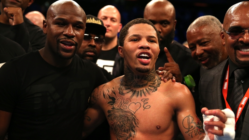 Mayweather (L) celebrates with IBF super-featherweight champ Gervonta Davis