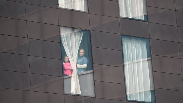 People affected by the deadly terror attack look out from a hotel window in Manchester