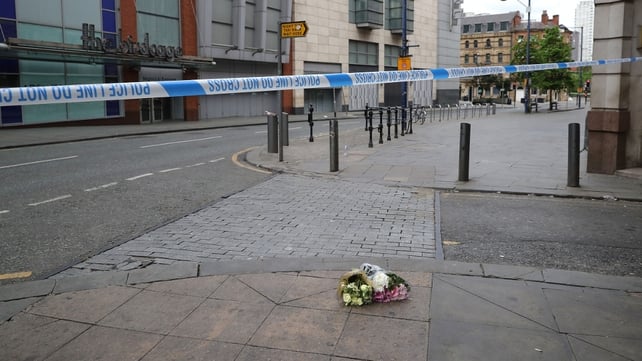 The first floral tributes to the victims of the terrorist attack are placed on the empty streets of Shudehill this morning