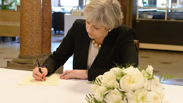 Prime Minister Theresa May signs a book of condolence for the victims of the attack