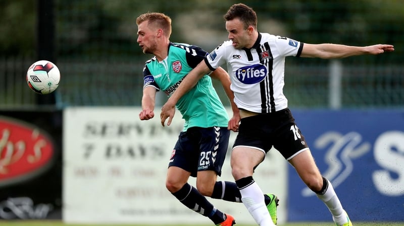 Dundalk's Robbie Benson and Lukas Schubert of Derry compete for the ball