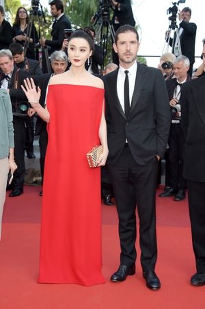 Day Eight - Wednesday May 24: Member of jury Fan Bingbing has so much allure in this Valentino Bardot dress alongside French actor Melvil Poupaud.