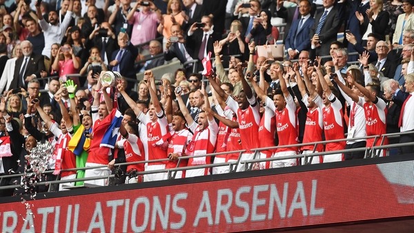 Per Mertesacker lifts the FA Cup at Wembley