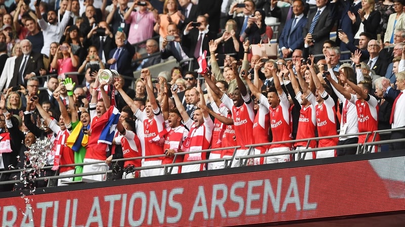 Per Mertesacker lifts the FA Cup at Wembley