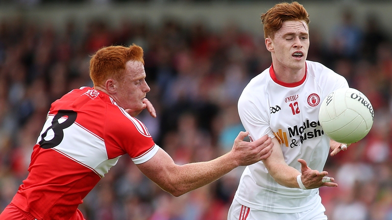 Tyrone's Conor Meyler is tackled Derry's Conor McAtamney