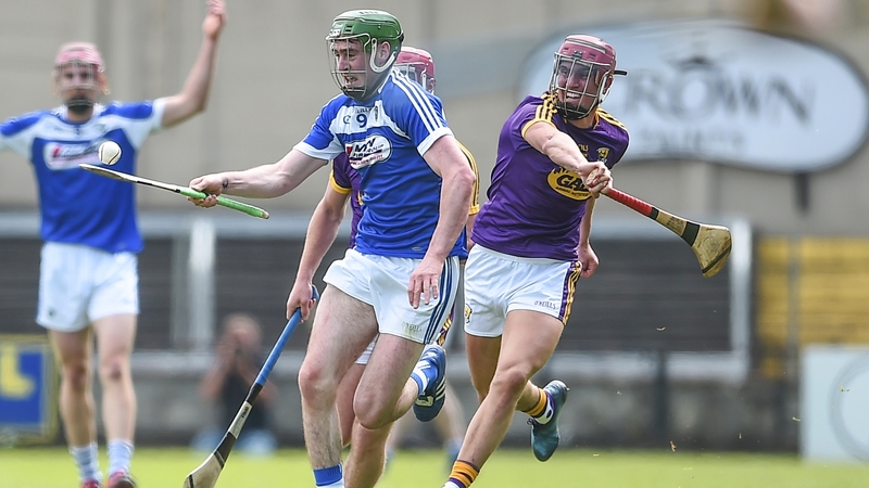 Patrick Purcell of Laois battles Wexford's Paul Morris
