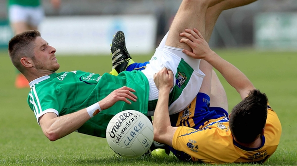 Clare's Martin McMahon with Danny Neville of Limerick get in a tangle