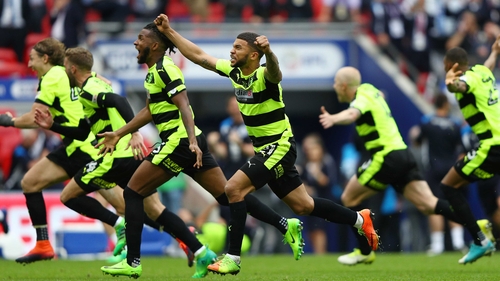 We're there! - Huddersfield players erupt after Christopher Schindler's decisive penalty kick