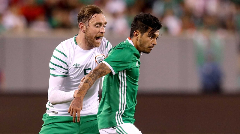 Richard Keogh challenges Mexico's Jesus Corona