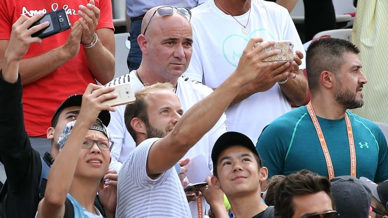 Fans snatch a selfie with Andre Agassi