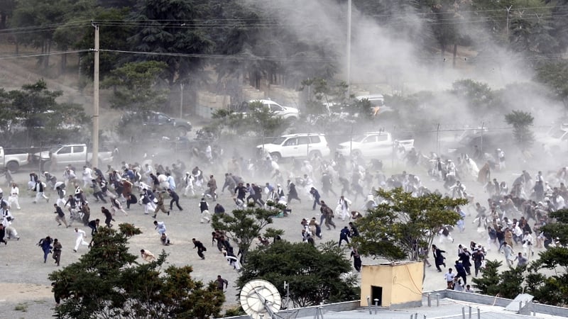 People run for cover was explosions go off at the funeral