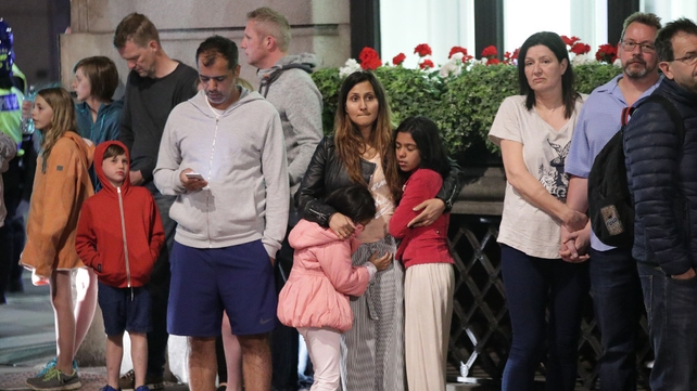 Families stand outside a hotel near Liverpool Street which was evacuated during the terror alert