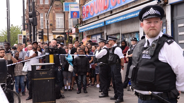 A crowd gathers behind a police cordon in Barking, east London, where there was a heavy police presence following last night's terrorist incident at London Bridge