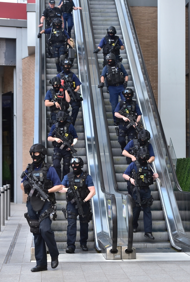 Armed police descend an escalator at the foot of the Shard outside London Bridge station, near the scene of last night's terrorist incident