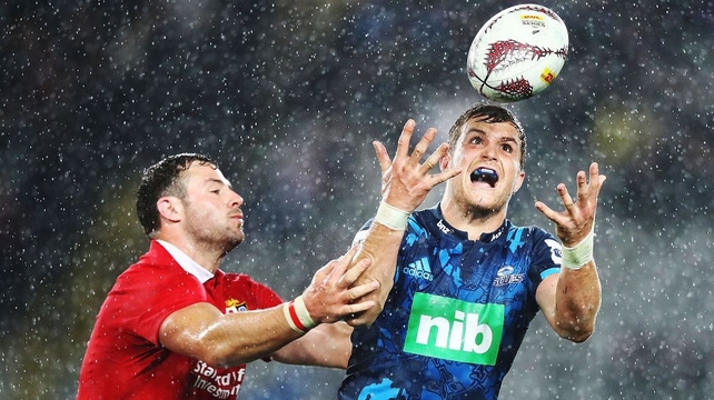 Michael Collins of the Blues collects the high ball under pressure from Robbie Henshaw