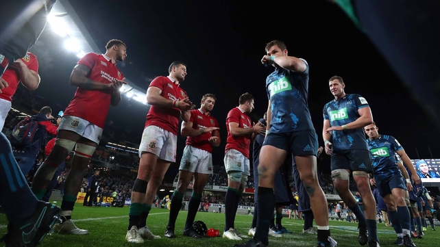 The Lions players applaud the Blues off the field