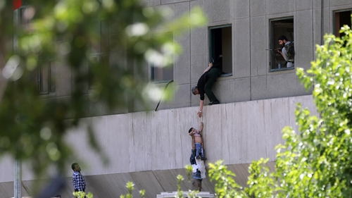 A child is rescued from the Parliament building in Tehran