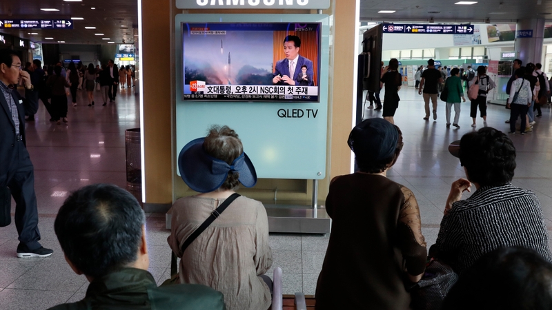 South Koreans watch a television broadcasting a news report on North Korea's recent missile launch