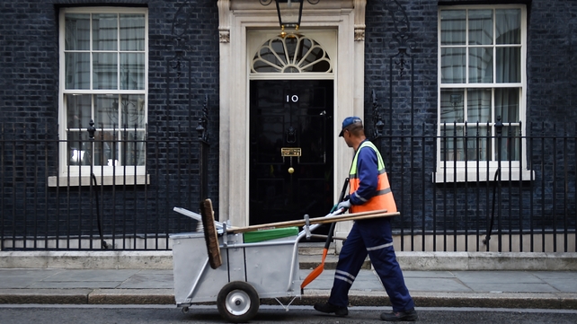 A street sweeper walks past 10 Downing Street as Theresa May's future was being openly questioned