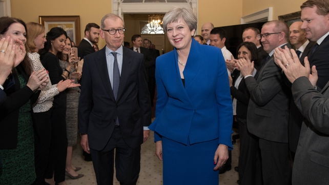 Theresa May and her husband Philip are clapped into 10 Downing Street by staff after seeing Queen Elizabeth where she asked to form a new government