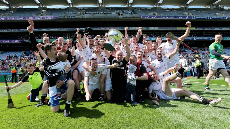The Warwickshire team and manager Tony Joyce celebrate with the cup