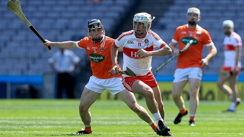 Armagh's John Corvan tries to dispossess Derry forward Mehaul McGrath