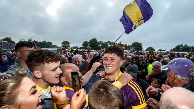 Lee Chin celebrates with supporters at the full-time whistle